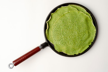 spinach or matcha russian pancakes on the pan isolated on