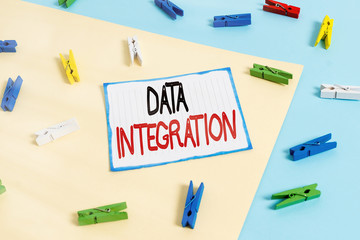 Conceptual hand writing showing Data Integration. Concept meaning combination of technical and business processes to combine Colored clothespin paper reminder with yellow blue background