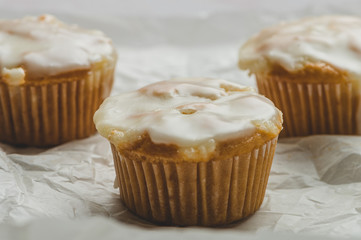Glazed Calamansi (Calamondin) Moist Muffins- Close Up on Parchment Paper Trio Horizontal