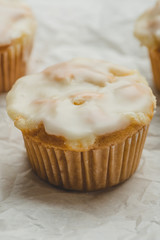 Glazed Calamansi (Calamondin) Moist Muffins- Close Up on Parchment Paper  Vertical