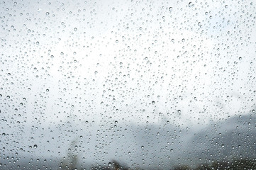 Droplets of water form on window of cruise ship., blurring the outside vista. 