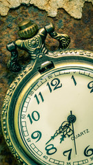 Vintage pocket watch showing time with textured background. concept of time