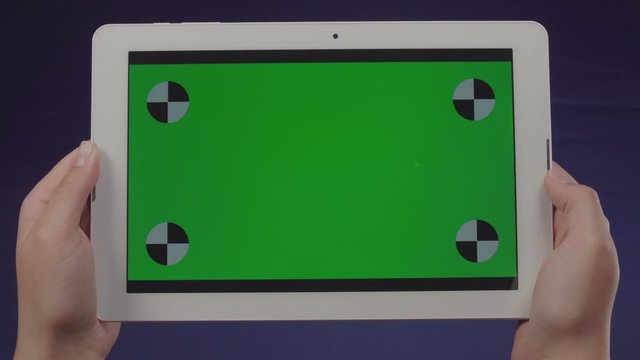 Woman using a tablet with green screen &ndash; Chroma Key