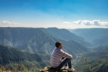 man watching the beautiful mountain range from edge of mountain