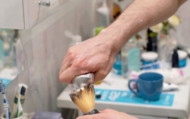 Man applying shaving foam to a brush