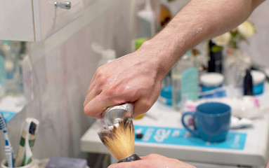 Fototapeta na wymiar Man applying shaving foam to a brush