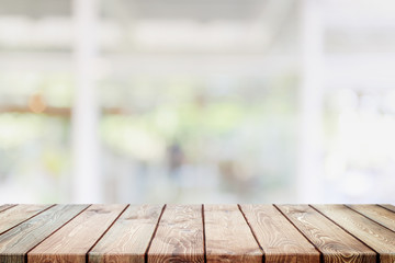 Empty wood table top and blurred coffee shop and restaurant interior background - can used for display or montage your products.