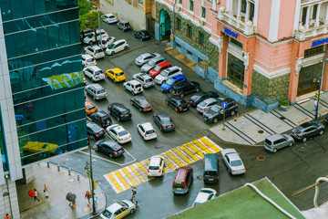Car traffic on the central street of Vladivostok, view from above. Busy intersection on Ocean...