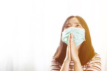 Softfocus of Young woman in hygienic mask are praying in the morning.