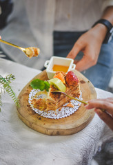 hand holding Medovik honey russian cake on top  strawberry ang kiwi 
