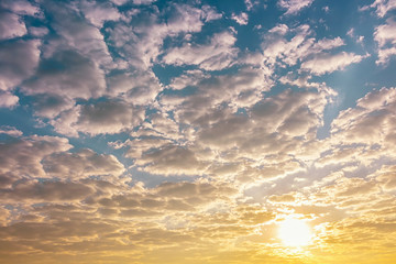 btight orange sunshine light in blue sky with clouds