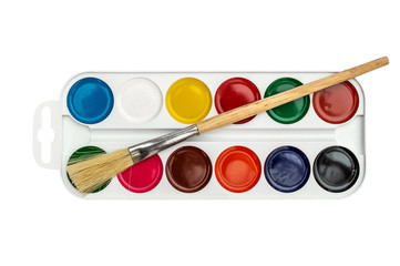 Watercolor paints with brush on white. Top view.