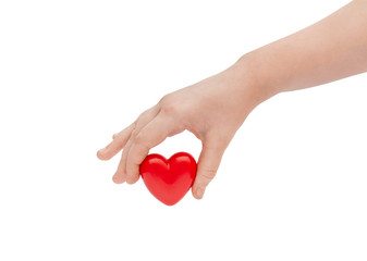 Child's hand holding red heart. Isolated on white.