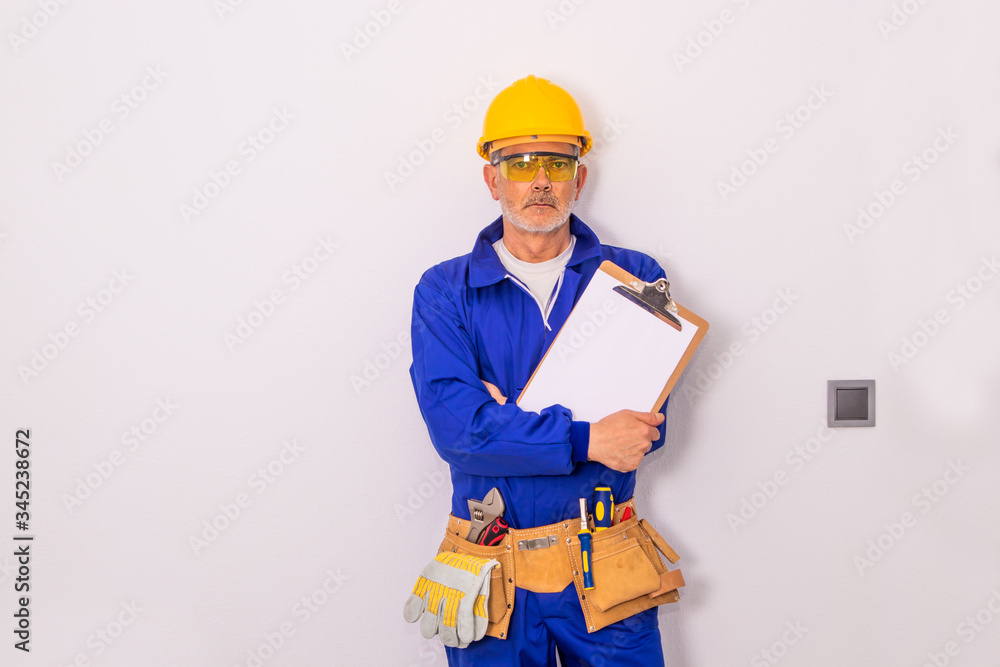 Wall mural construction worker or professional man with tools and helmet