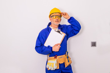 construction worker or professional man with tools and helmet