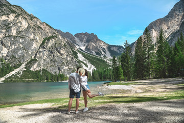 Fototapeta na wymiar couple kissing at summer lake in mountains