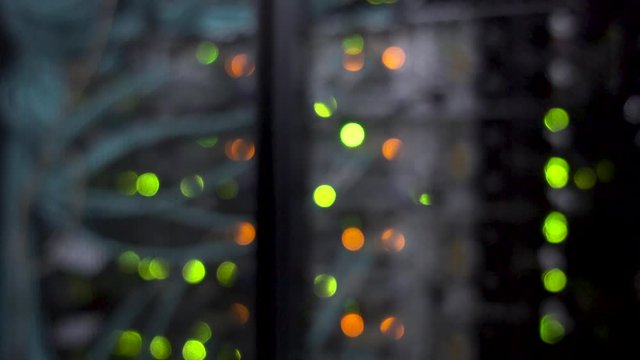 Colorful bokeh with blinking multicolored neon lights server room.