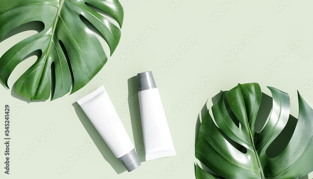 Wall mural cosmetics products on green background and tropical monstera leaves. beauty concept. 3d rendering