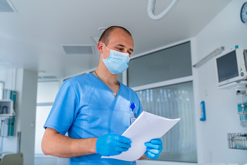 Doctor in mask. Special modern chamber in hospital. Modern medical bed and a special device in the...