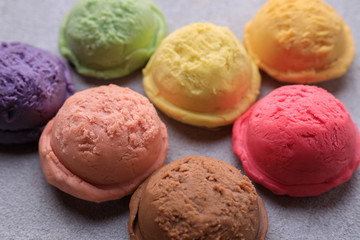 Various flavored ice cream scoops, close up. Food background, refreshment, rainbow, variety, cool seasonal sweets, refreshment concept