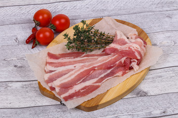 Raw bacon on the board