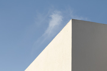 Minimal background in architectural style. White walls against the blue sky.