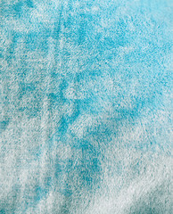 Blue silk fabric as background.