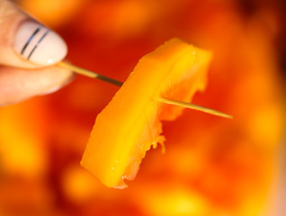 Sliced mango fruit in the girl’s hand