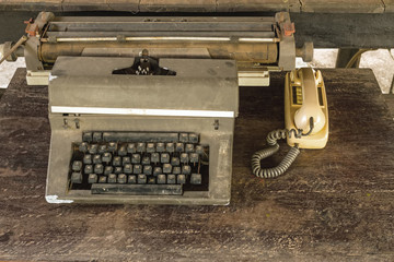 Vintage typewriter  and old telephone on old wooden touch-up in still life concept