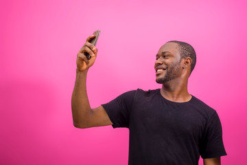 young black happy man using his smartphone to chat
