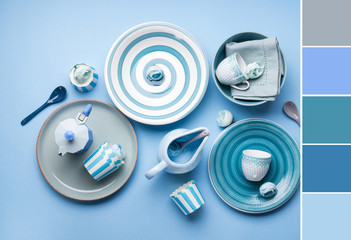 Blue pastel ceramic tableware crockery set on abstract background. Color swatch