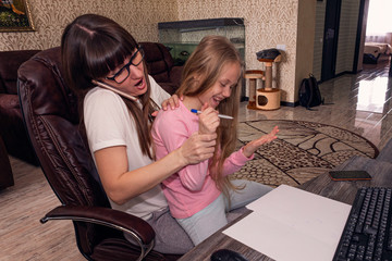Mother working from home with kids. Quarantine and closed school during coronavirus outbreak....