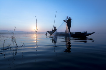 Naklejka premium fisherman asia silhouette morning sun rise