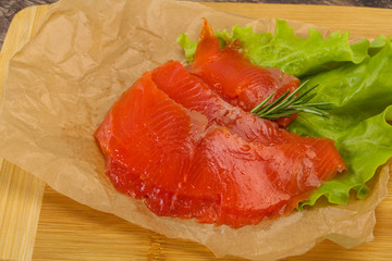 Sliced salmon fillet served rosemary