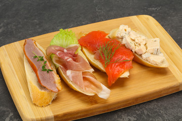 Tapas - bruschetta with prosciutto, salmon, duck and gorgonzola