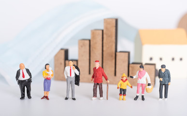 Miniature people family with surgical mask,business graph and house icon on white background due to Coronavirus disease (COVID-19) prevention,people or economy