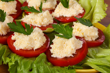 Tomato slices with cheese served parsley