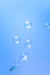 Blowing soap bubbles on blue background