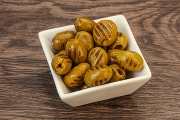 Green grilled olives in the bowl