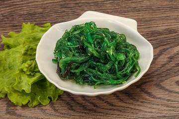 Green Chuka Seaweed Salad Isolated on White Background Top View. Wakame Sea Kelp Salat