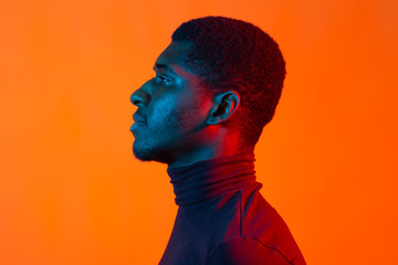 Neon portrait of young african american man, side view