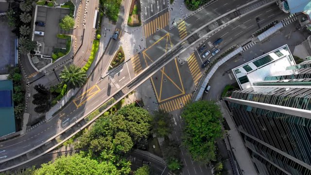 Aerial view of the modern city from a height. The camera slowly drops over a busy intersection in the modern metropolis