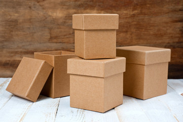 Cardboard boxes of different sizes with lids. Background for gift wrapping. Products from natural materials.
