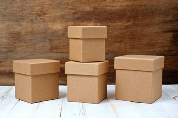 Cardboard boxes of different sizes with lids. Background for gift wrapping. Products from natural materials.