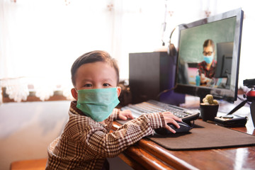 Asian kid use medical mask or surgical mask to protect her from virus, sickness, Covit-19 and coronavirus infection.