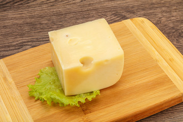 Emmental cheese over wooden board