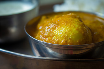 View of egg curry meal with white rice in background. Egg masala with rice. Spicy egg gravy.