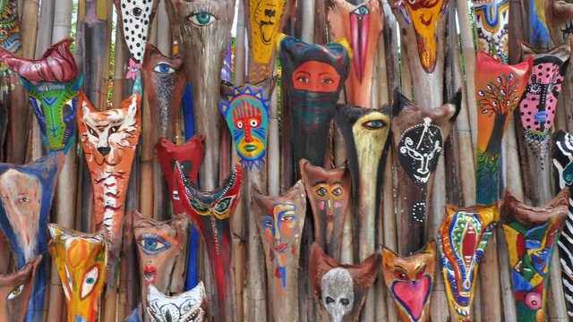 Colorful  shamans masks on the art market wall at tropical island koh Phangan in Thailand