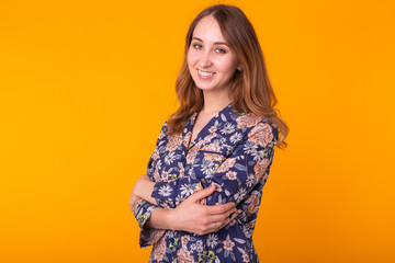 Obraz premium Fashion portrait pretty cool girl in home wear pajama having fun over colorful yellow background.