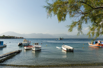 Fototapeta na wymiar fishing boats in the harbor, coast of the mediterranean sea, Greece